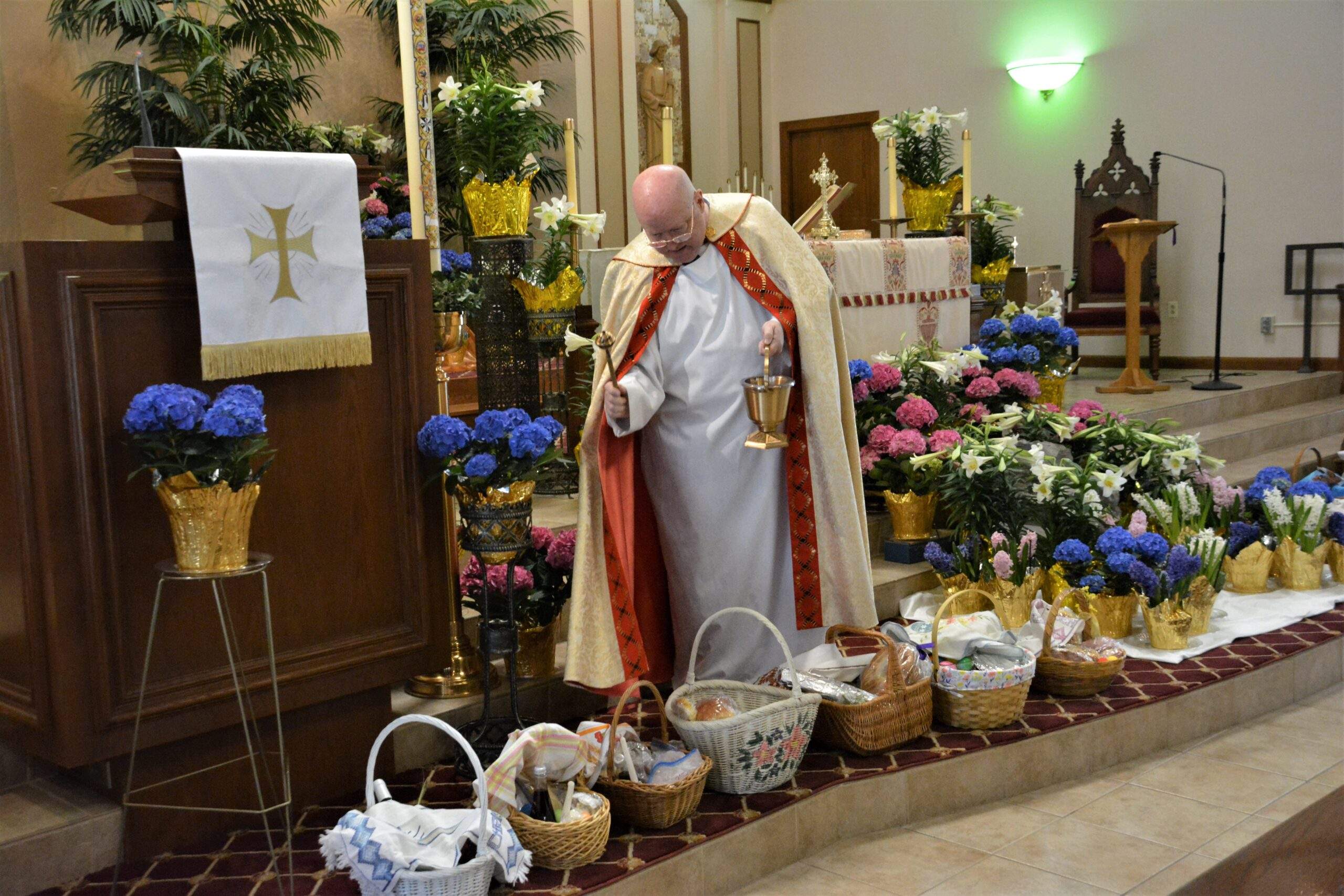 Fr. Kelly blesses more than 20 Easter Baskets around the altar at St. Rose.