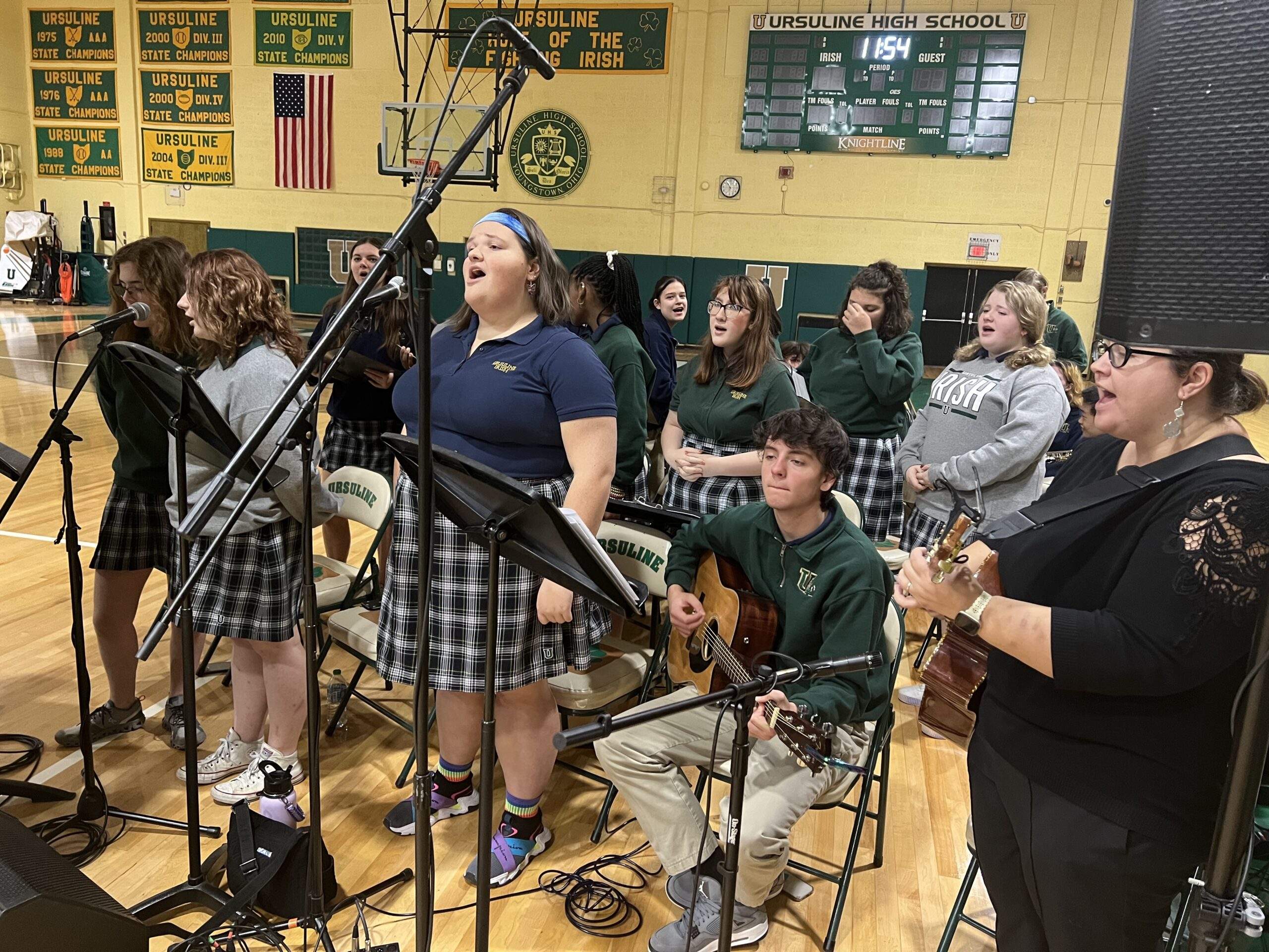 Ursuline high school students sing and play instruments at the Thanksgiving Day Mass in their gym