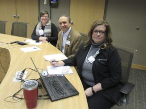 Mercy Medical mission staff sit around a table.