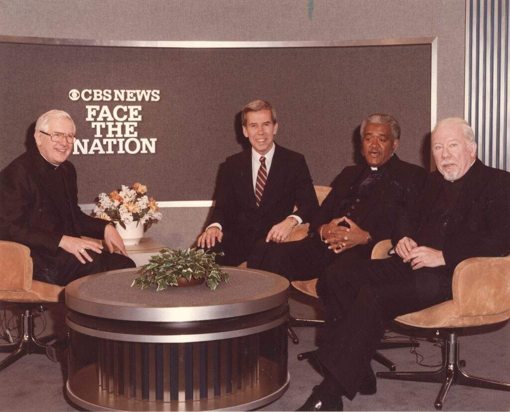 Three priests and the host, including Bishop Malone, talk on CBS News Face the Nation