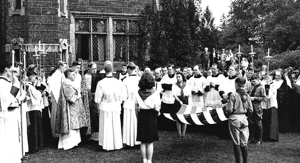 A large crowd stands in front of the new convent in this black and white photo