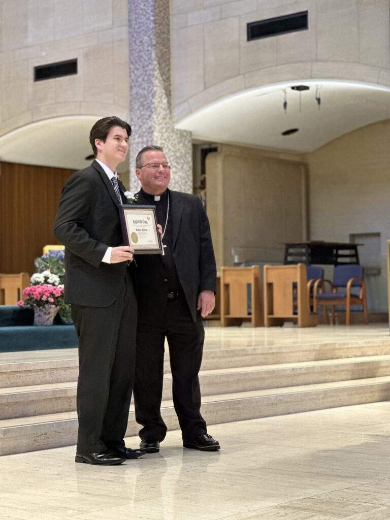 Recipient poses with bishop bonnar.