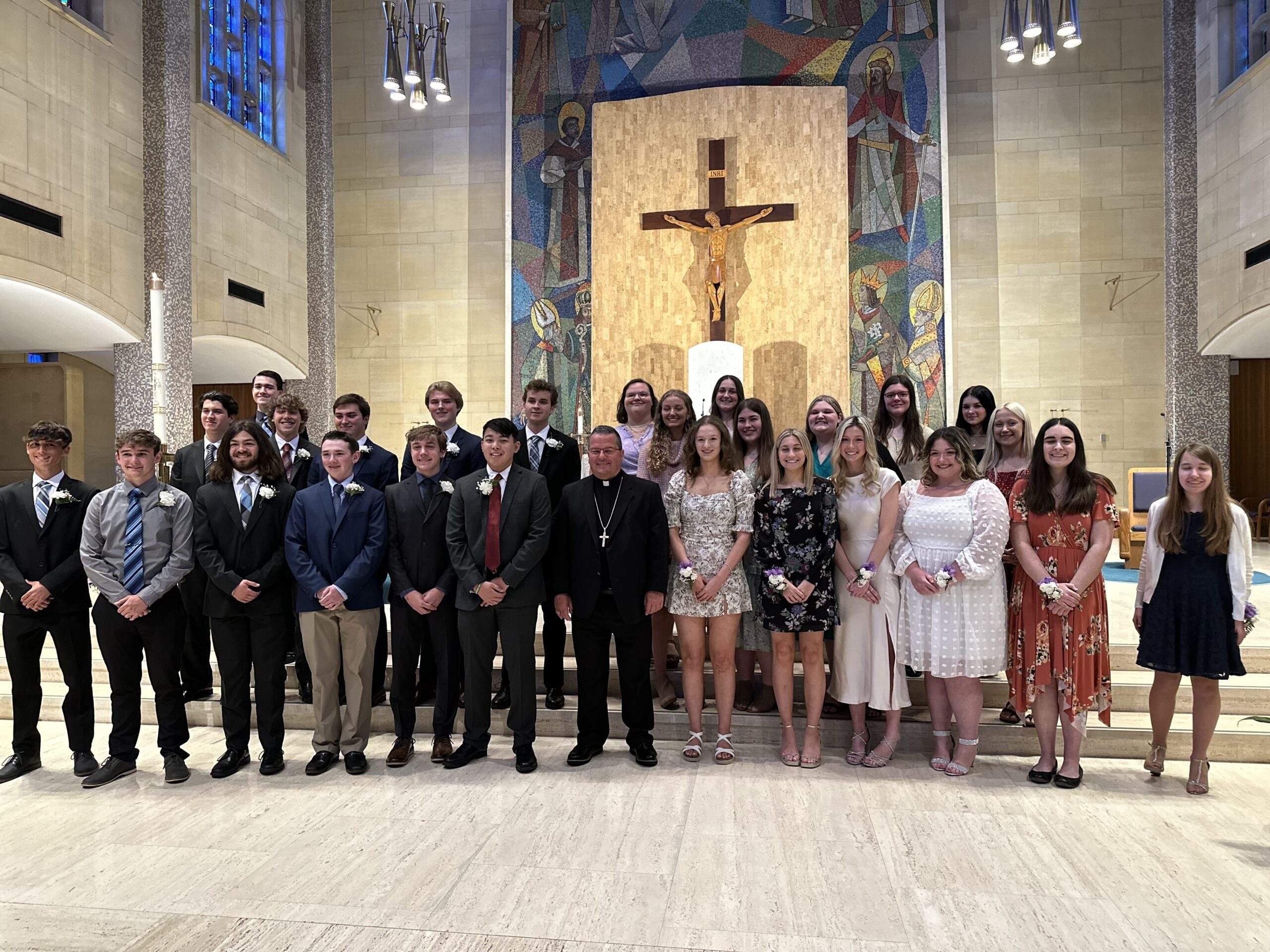 The Eagle of the Cross award recipients pose with the bishop in front of the altar at St. Columba Cathedral.