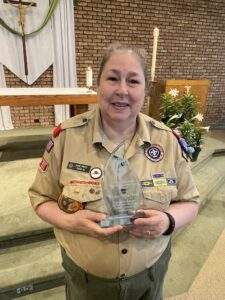 Martha holding a glass trophy.