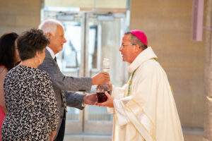 Bishop receives the gifts during the offertory