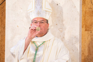 bishop shows coin from past bishop
