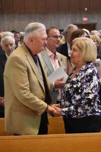 Couple holds hands during the renewal of vows.