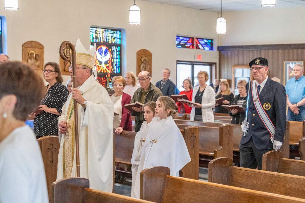 Young female altar servers walk in procession at Sacred Heart in Rock Creek. Photo by Brian Keith