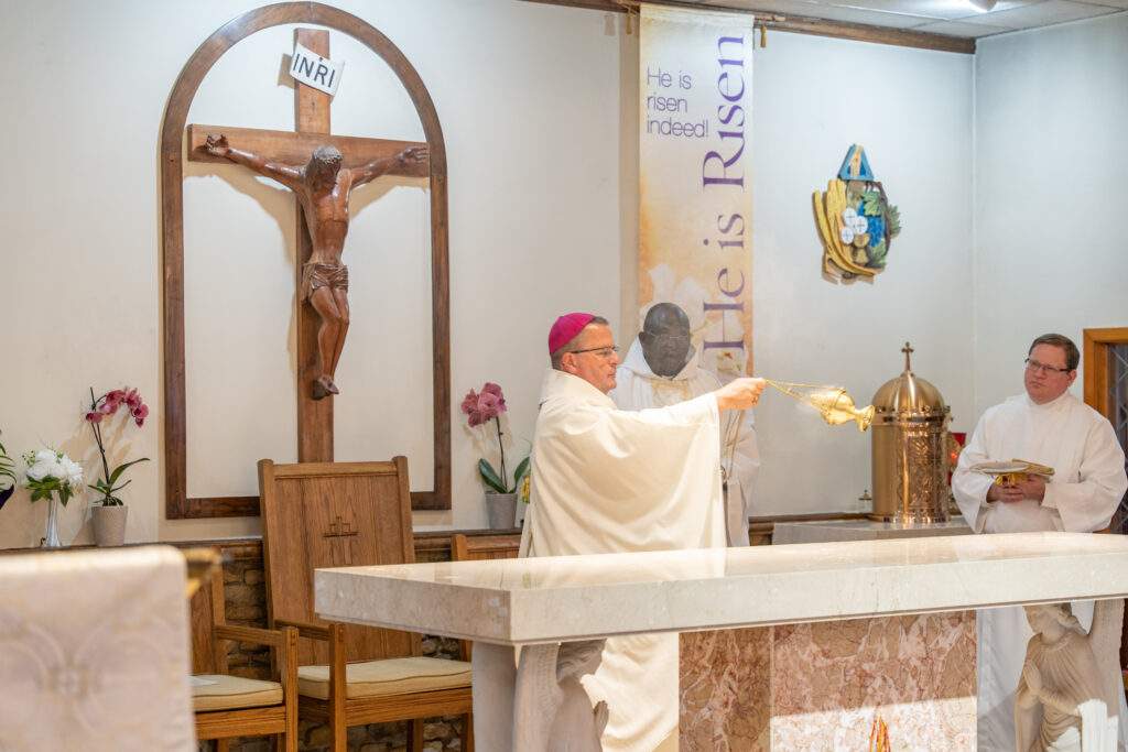 Bishop Bonnar incenses the altar during altar blessing at Sacred Heart Parish in Rock Creek. Photo by Brian Keith.