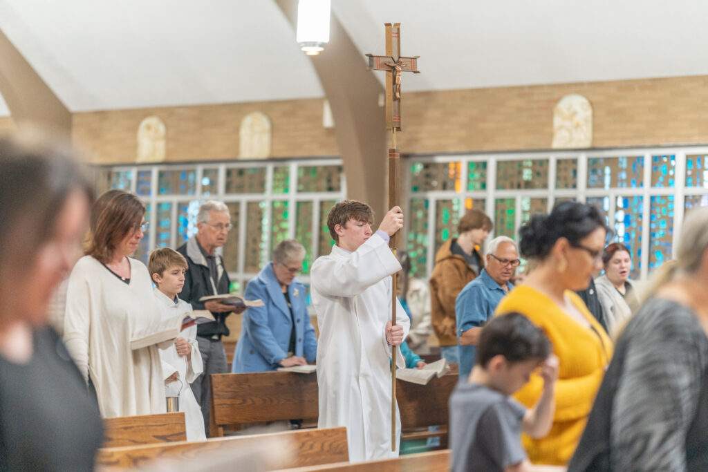 Altar server walks in procession with cross at St. Mary Parish in Orwell. Photo by Brian Keith