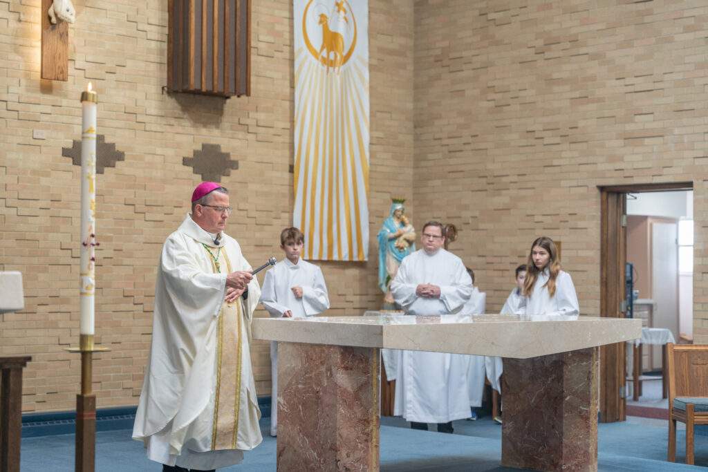 Bishop Bonnar sprinkles holy water on the altar during the altar blessing Mass on May 7 at St. Mary Parish in Orwell. Photo by Brian Keith