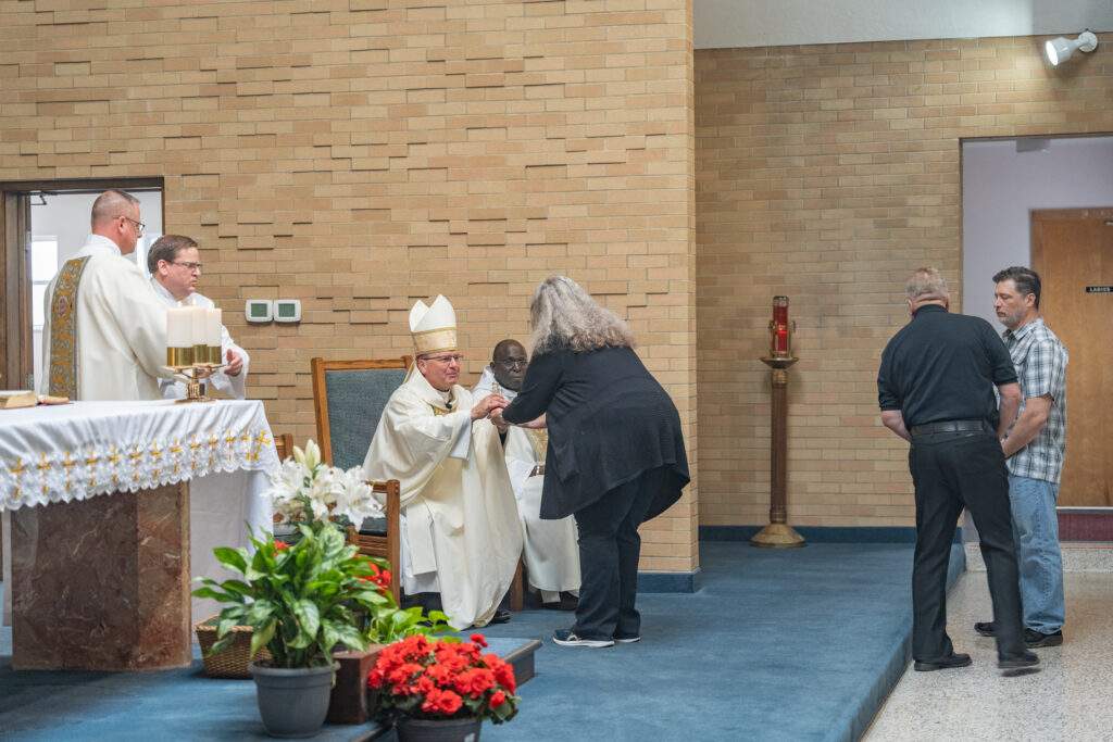 Parishioners bring gifts forward and present to Bishop Bonnar at altar blessing at St. Mary's Parish in Orwell. Photo by Brian Keith