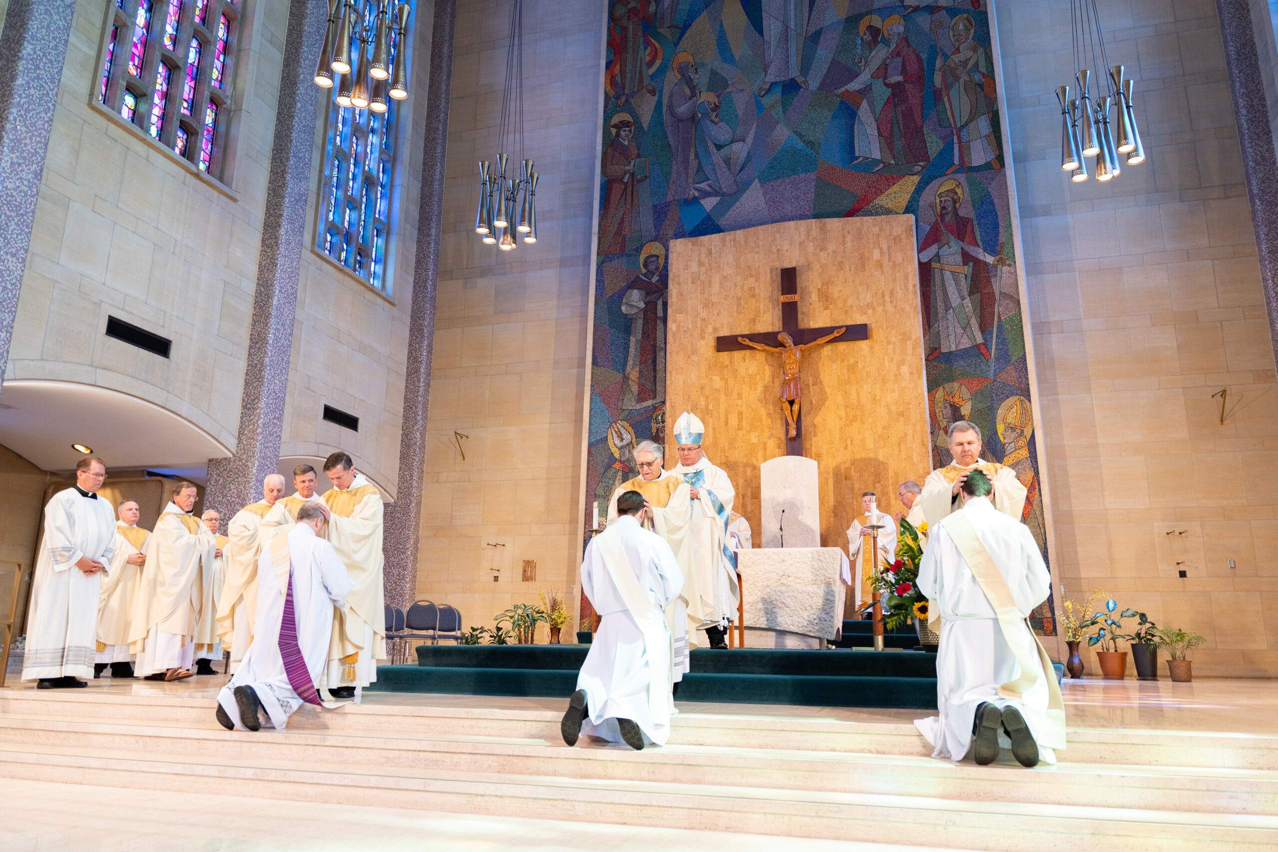 their hands upon the ordinands, signifying the unity of the priesthood. Photo by Brian Keith