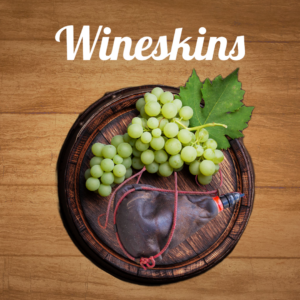 Wine barrel with grapes and wineskin