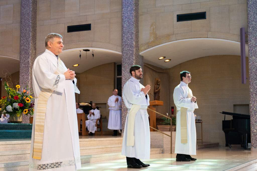 Father England, Father Schlueter and Father Rovnak stand before the faithful at their ordination Mass on June 17, 2023.