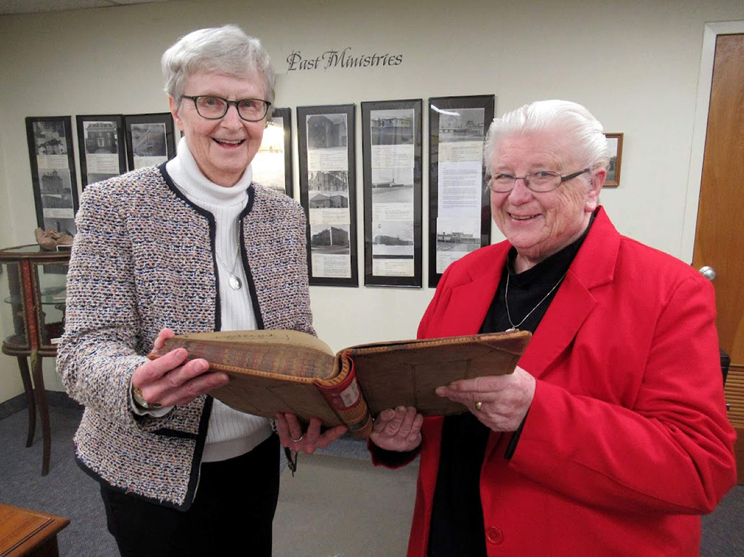 Ursuline Sisters Patricia McNicholas and Carole Suhar review materials from the archives of the Ursuline Sisters of Youngstown, in preparation for the anniversary.