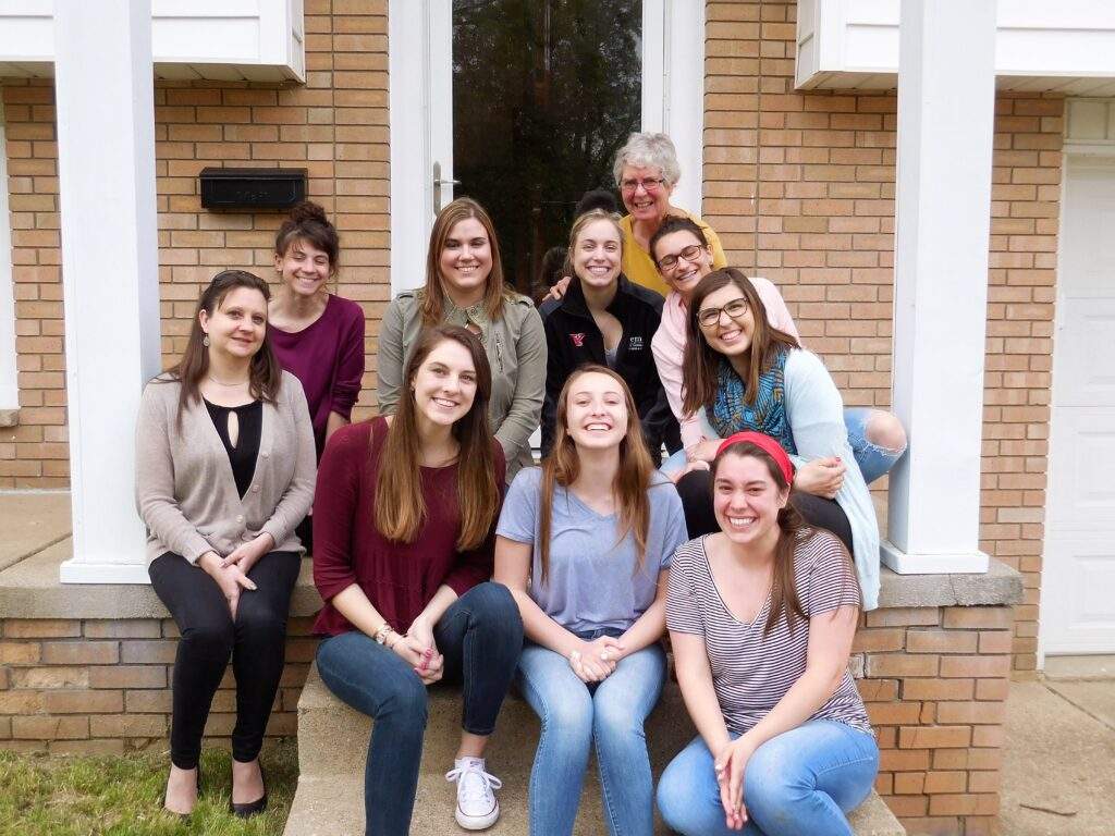 Sister Norma Paupple, poses with a group of young adult volunteers.