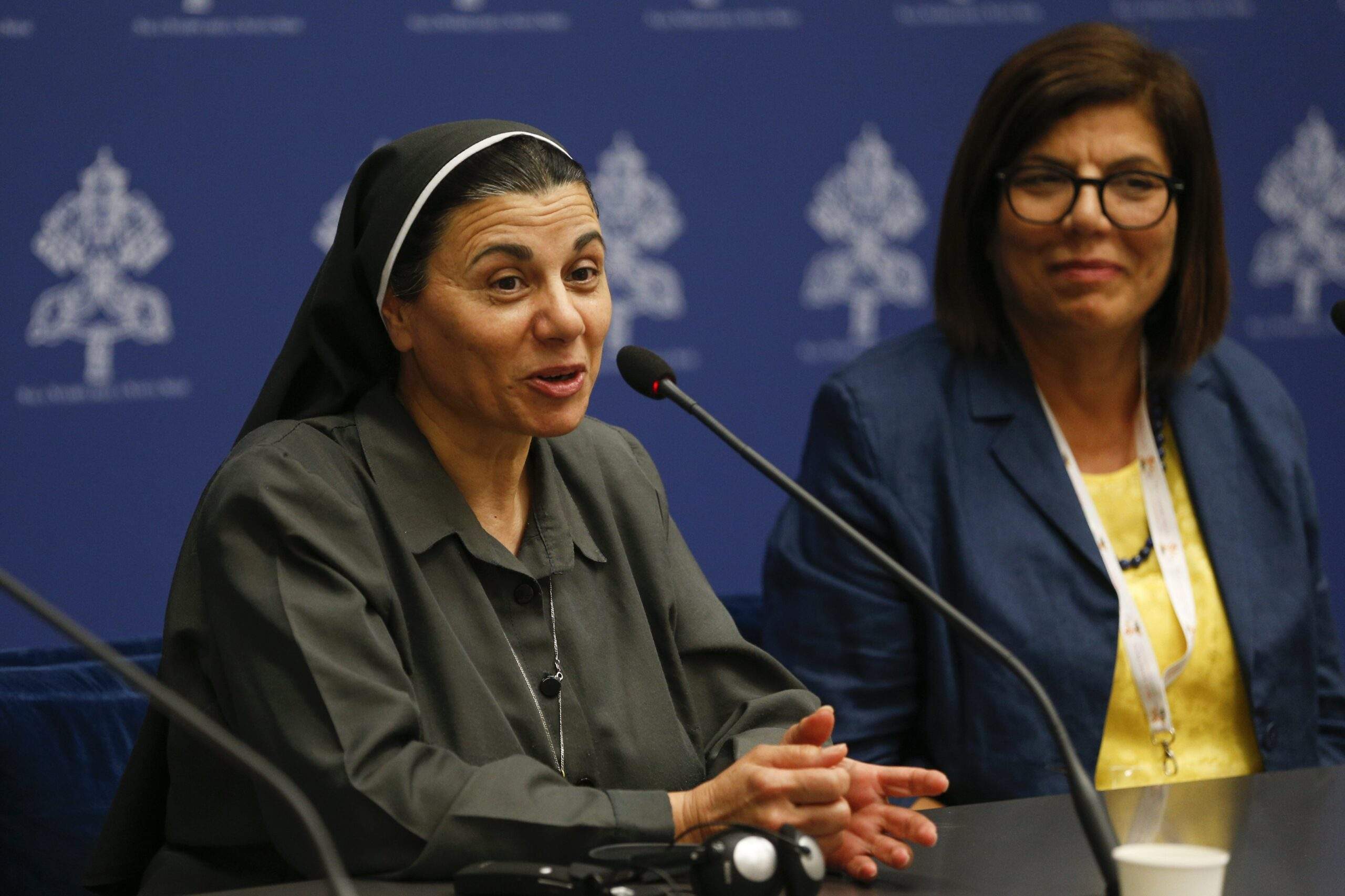 Iraqi Sister Caroline Saheed Jarjis, a member of the Daughters of the Sacred Heart of Jesus, speaks to reporters Oct. 12, 2023, during a briefing about the assembly of the Synod of Bishops in the Vatican press office. Margaret Karram, the Israel-born Palestinian president of the Focolare movement, listens as she speaks. (CNS photo/Robert Duncan)
