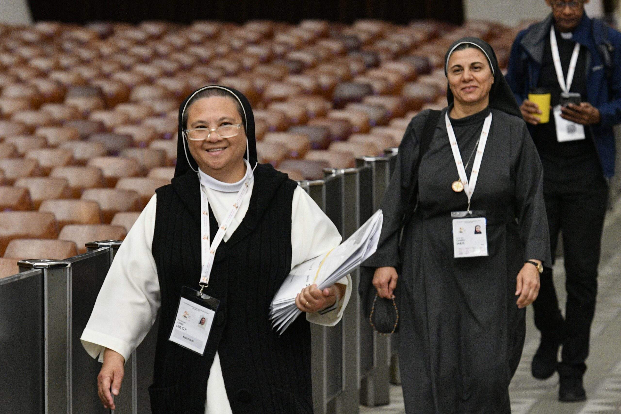 Sister Loida Lim, a member of the Missionaries of St. Dominic, and Sister Caroline Saheed Jarjis, a member of the Daughters of the Sacred Heart of Jesus, arrive for the afternoon session of the assembly of the Synod of Bishops in the Paul VI Audience Hall at the Vatican Oct. 13, 2023. (CNS photo/Vatican Media)