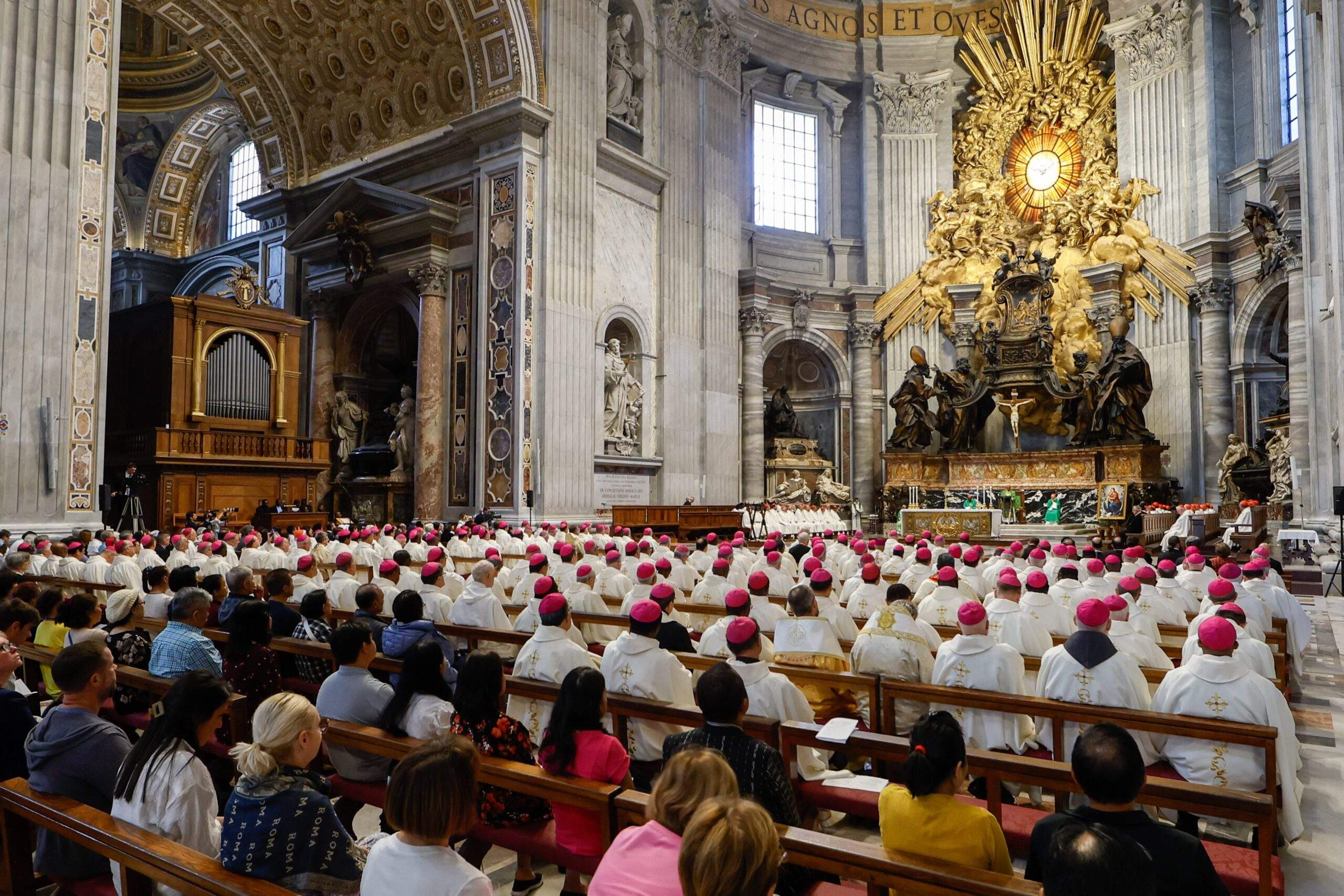 Participants in the assembly of the Synod of Bishops attend Mass presided over by Congolese Cardinal Fridolin Ambongo of Kinshasa at the Altar of the Chair in St. Peter's Basilica at the Vatican Oct. 13, 2023. (CNS photo/Lola Gomez)