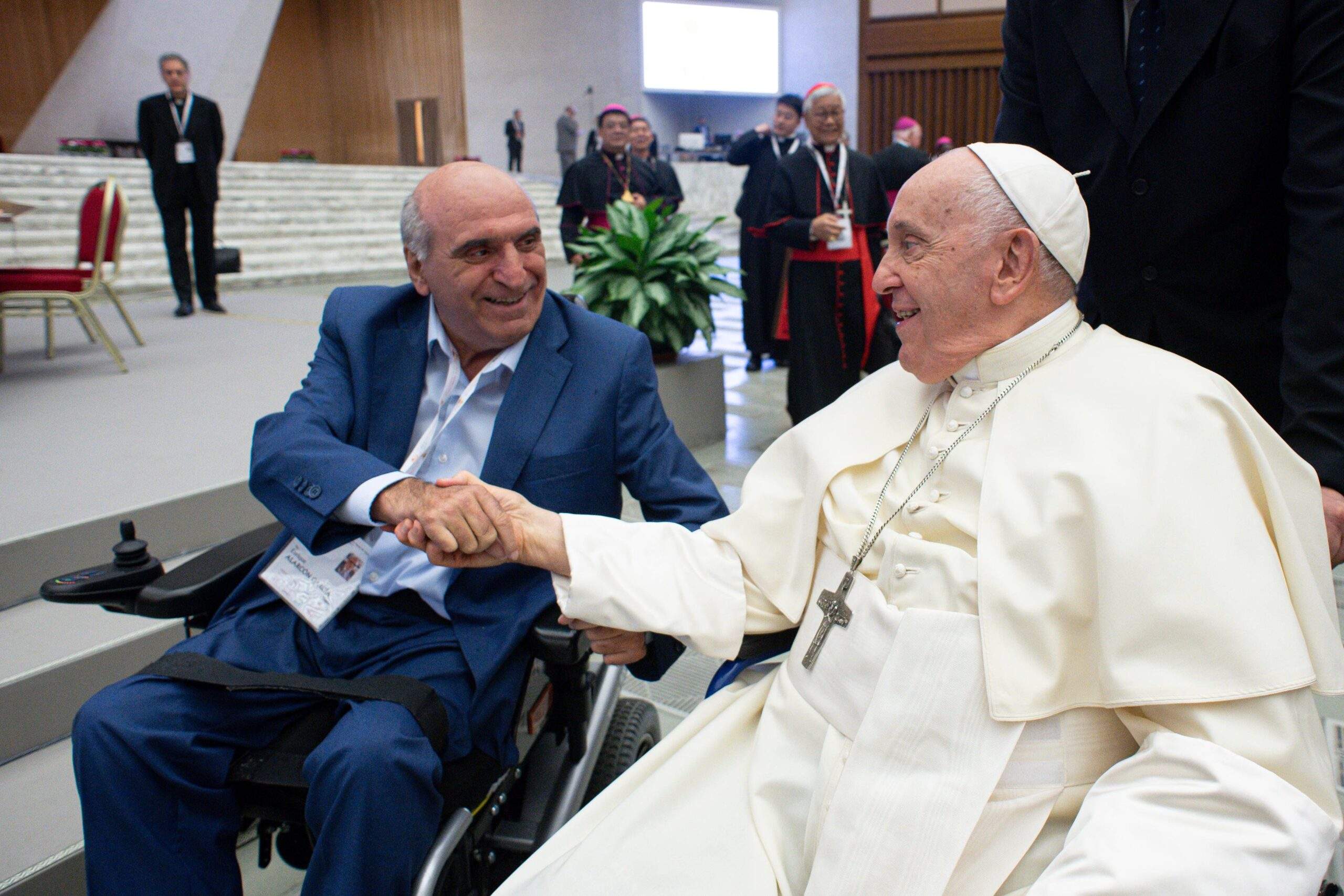 Enrique Alarcón García, a member of the synod and president of Frater España, a Christian fraternity of people with disabilities in Spain, greets Pope Francis on the first day of the assembly of the Synod of Bishops, Oct. 4, 2023, in the Paul VI Audience Hall at the Vatican. (CNS photo/Vatican Media)