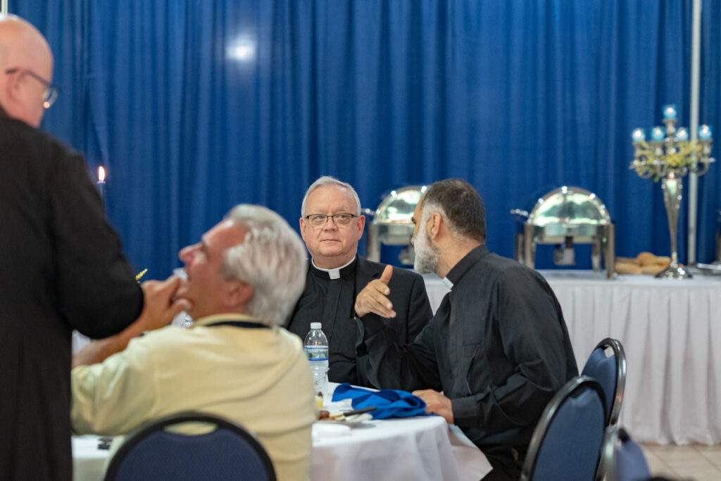 Monsignor Siffrin seated at dinner
