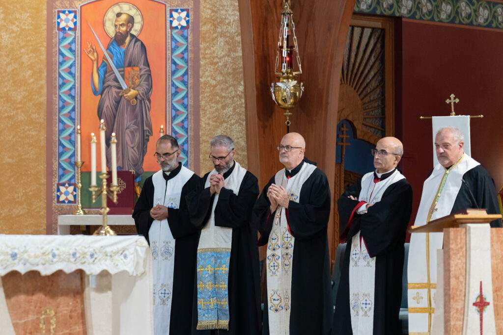 Maronite priests watch bishop bonnar perform the Eucharistic prayers