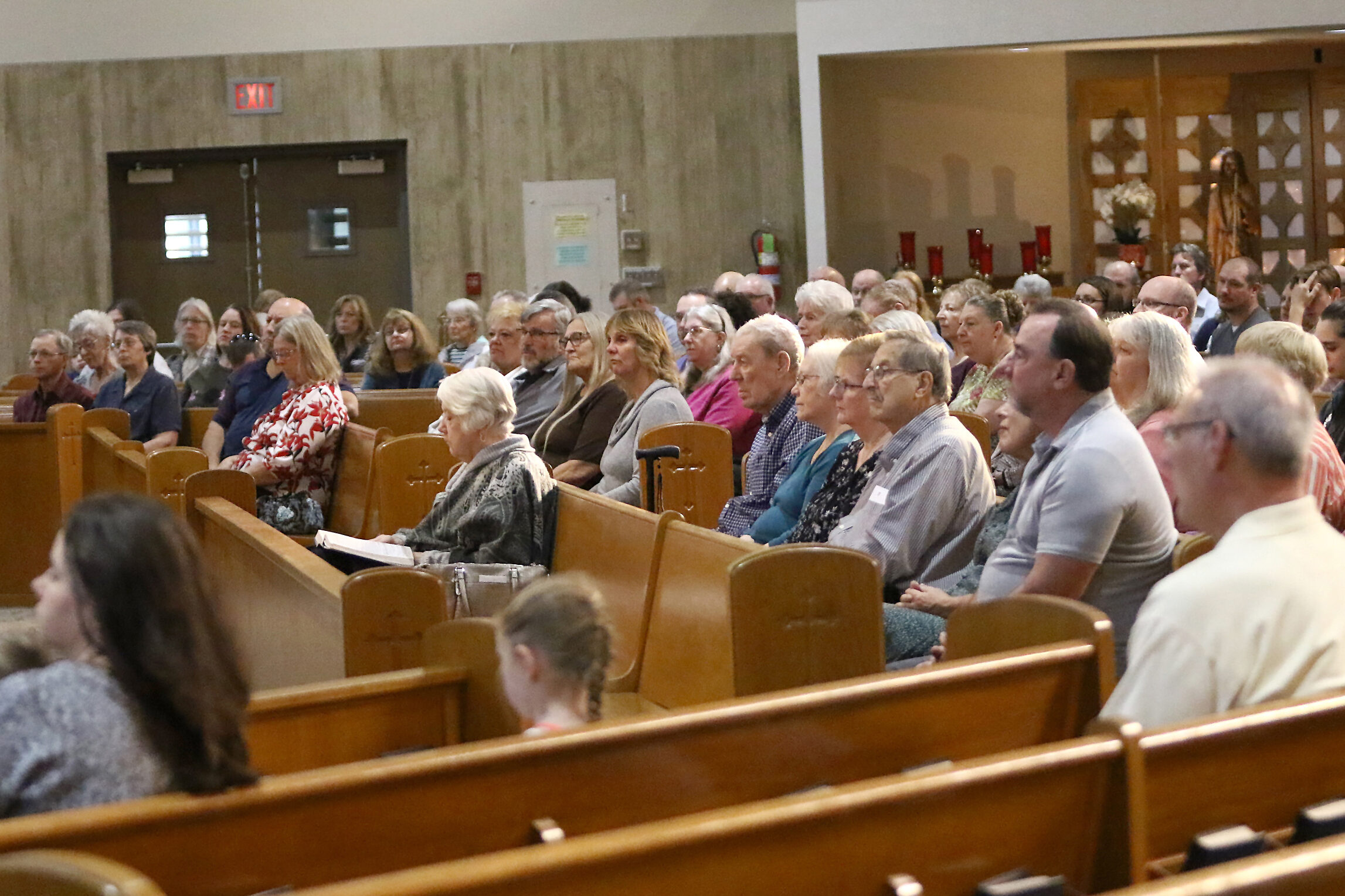 Seated parishioners listen to a homily. 