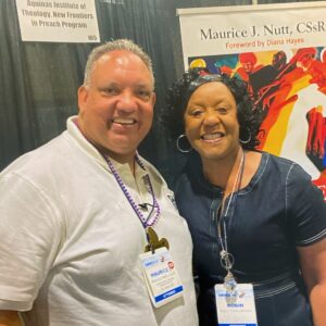 Robin poses with presenter at National Black Catholic Congress