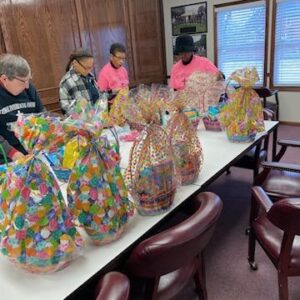 Volunteers assemble Easter Baskets