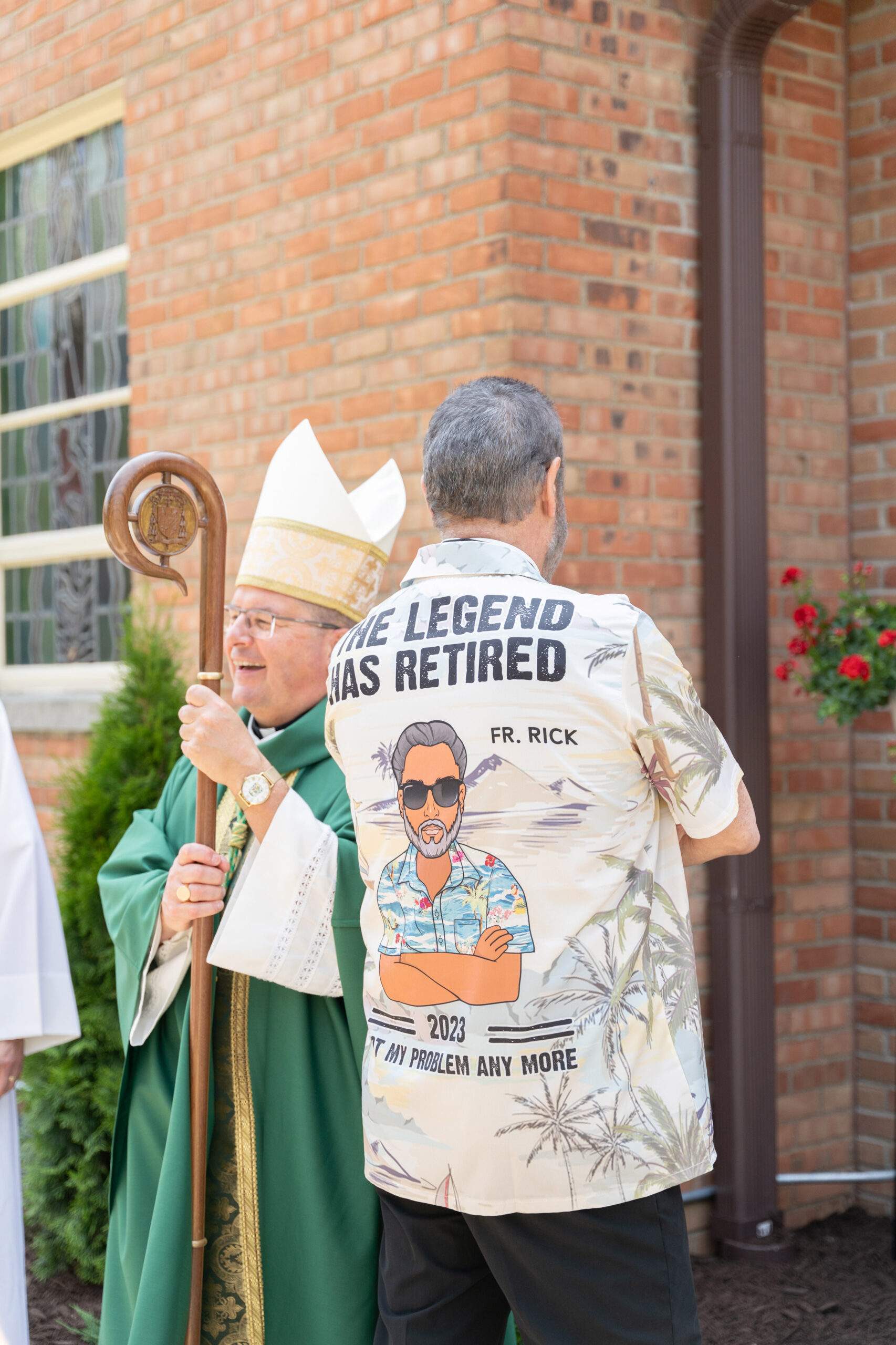 Father Richard Pentello after his retirement Mass, wearing a custom-made Hawaiian shirt stating "The legend has retired."