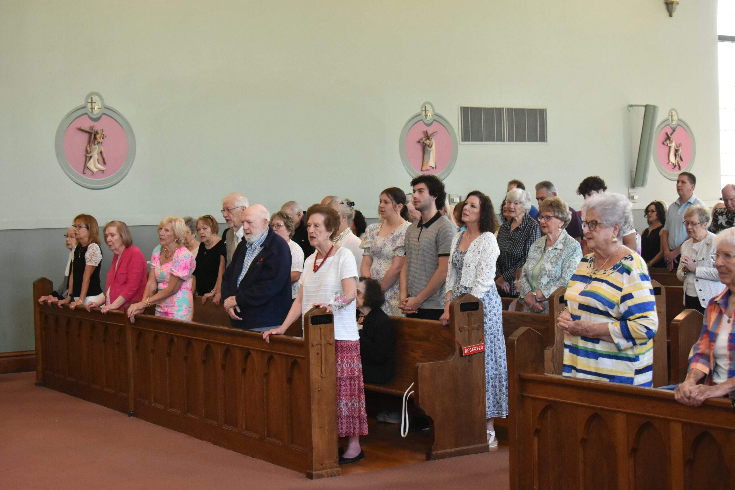 Parishioners stand at Mass at St. Brendan Parish.