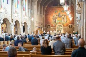 Parishioners stand during Mass at St. Dominic Parish in Youngstown