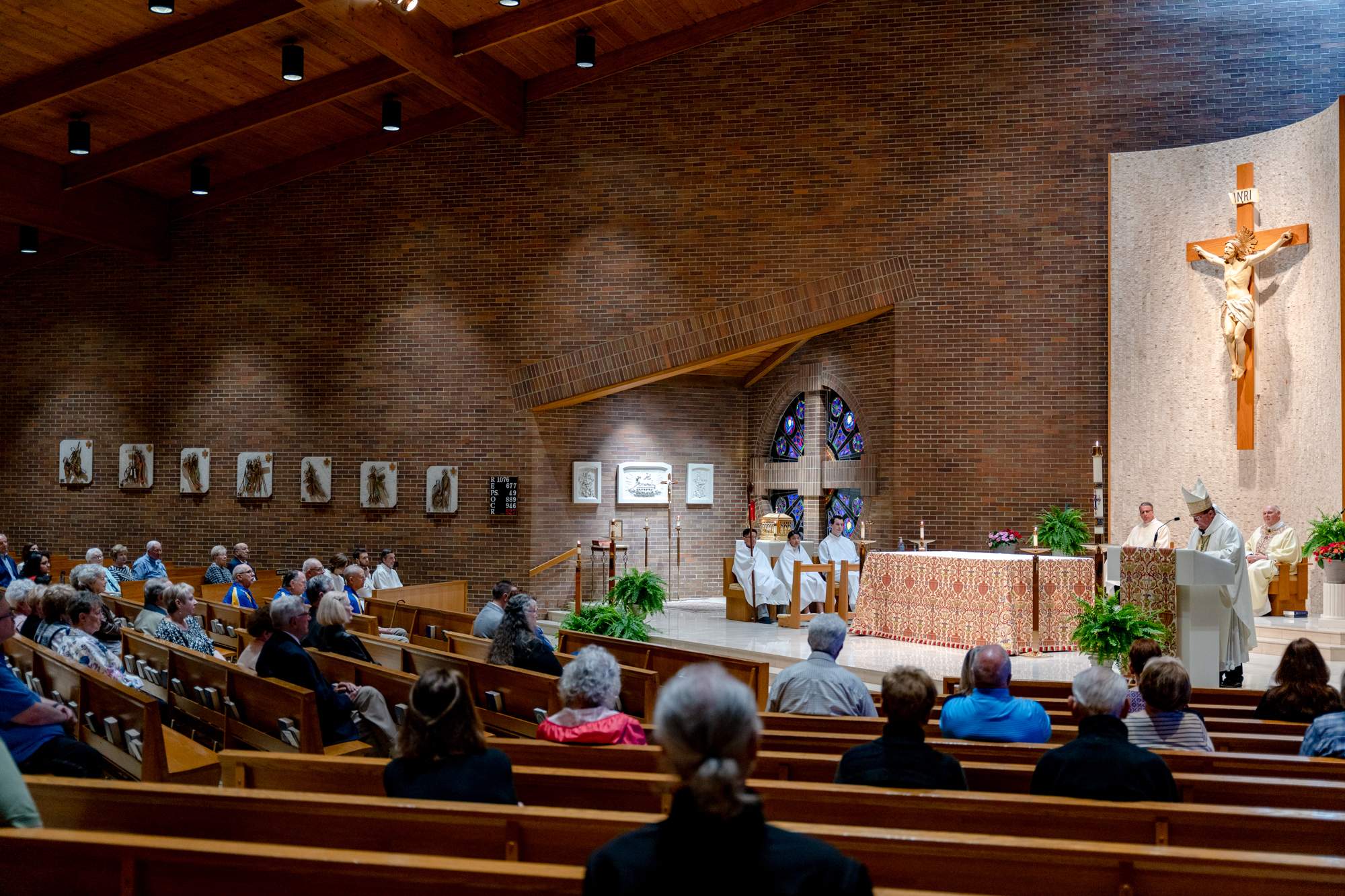 Seated parishioners at Our Lady of Sorrows Parish watch Mass