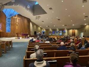 Parishioners listen to a band in the front of the sanctuary