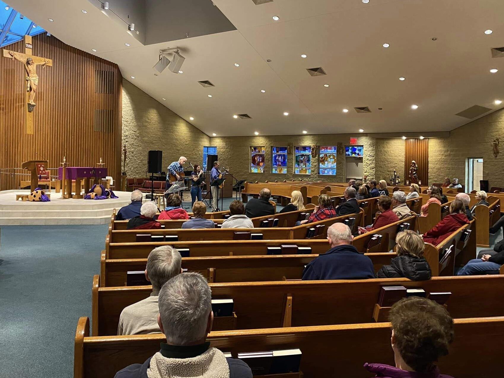 Parishioners listen to a band in the front of the sanctuary