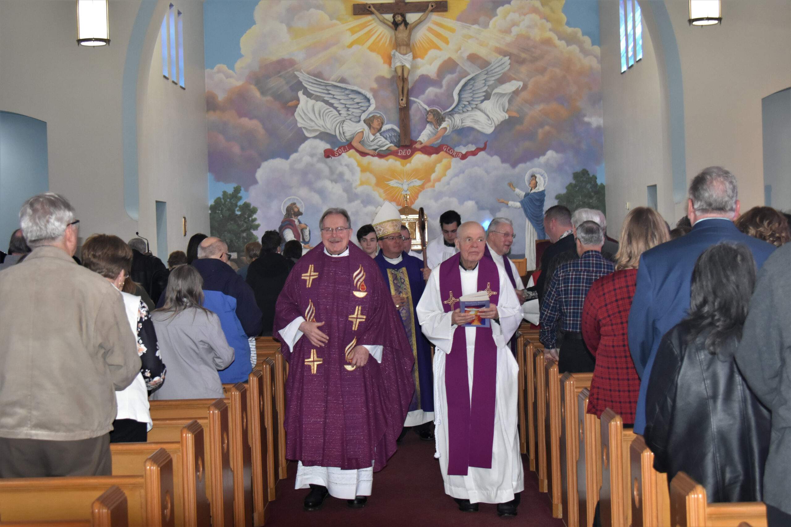 Bishop Bonnar and clergy walk in procession out of the church during the anniversary Mass