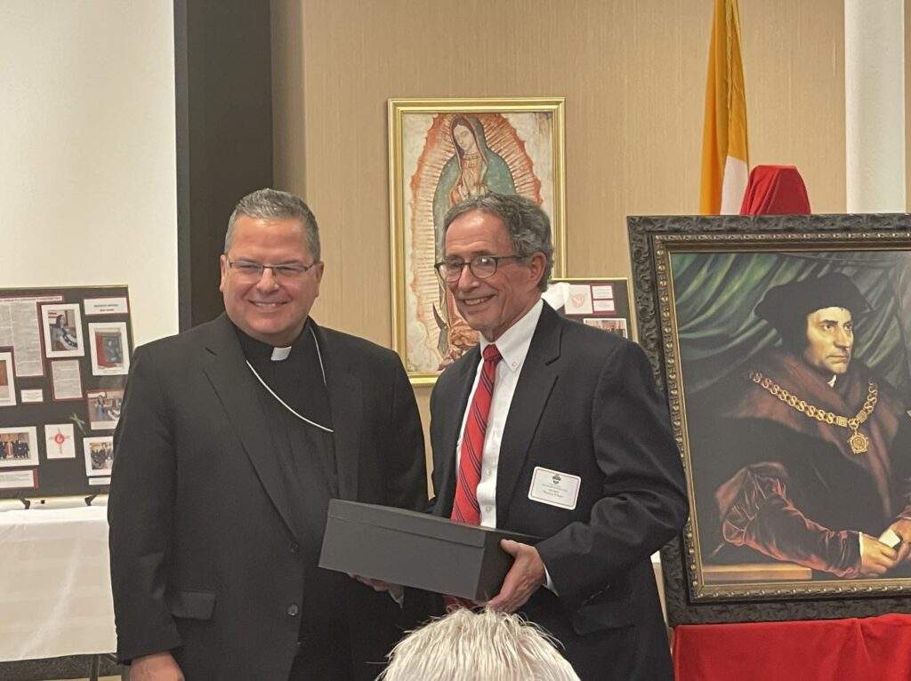 Attorney Tom Wilson receives an award at the reception after the Red Mass
