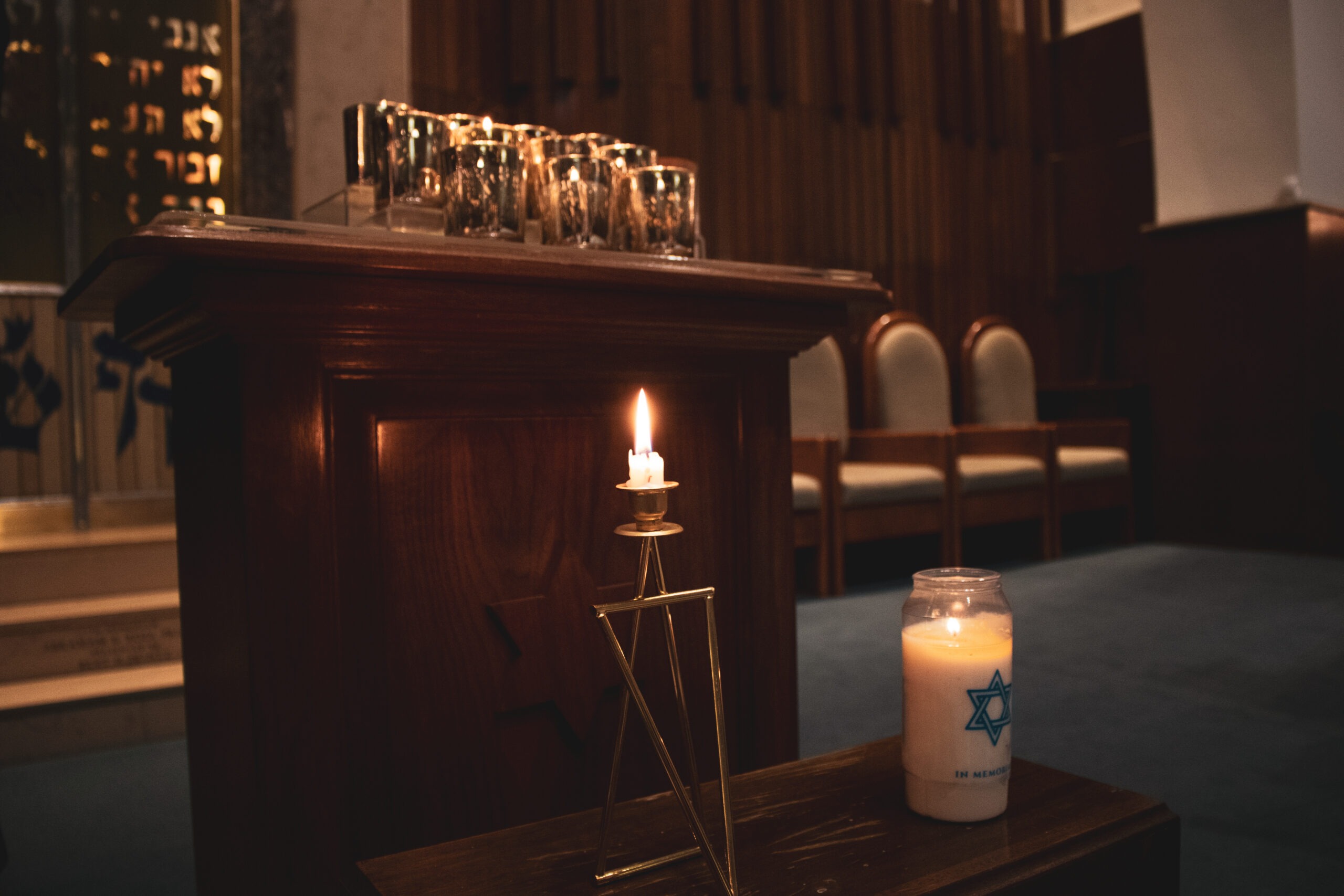 A candle is lit in front of the altar at the service for the memory of the Pittsburgh Synagogue shooting victims. Photo by Olivia Miller