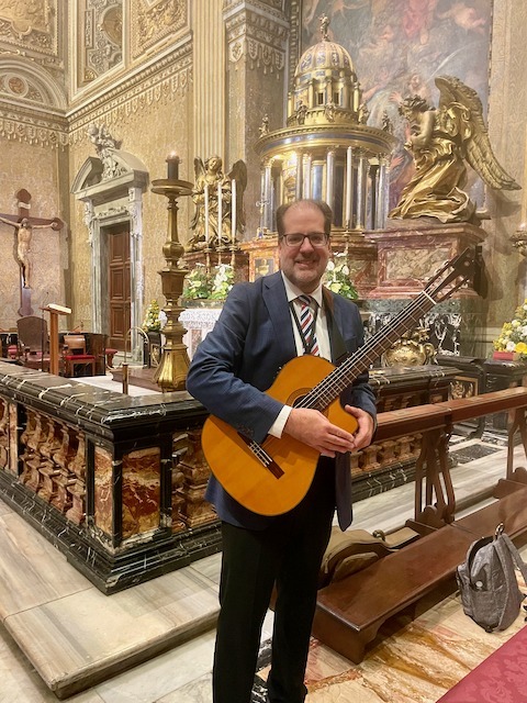 Fernandez poses with a guitar in St. Peter's Basilica, Rome