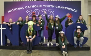 Students pose around NCYC sign