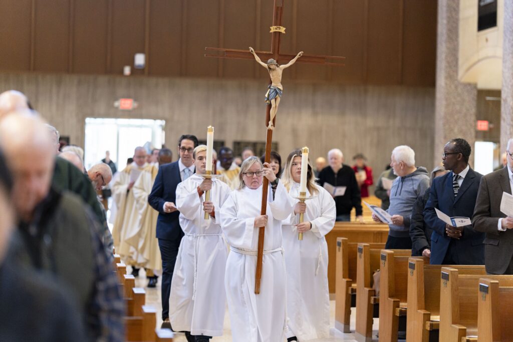 Servers walk in procession, followed by priests and deacons at the annual White Mass. Photo by Brian Keith