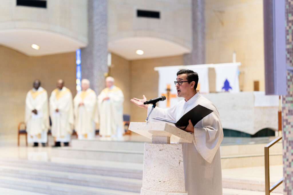 Cantor leads the congregation in song at the annual White Mass. Photo by Brian Keith