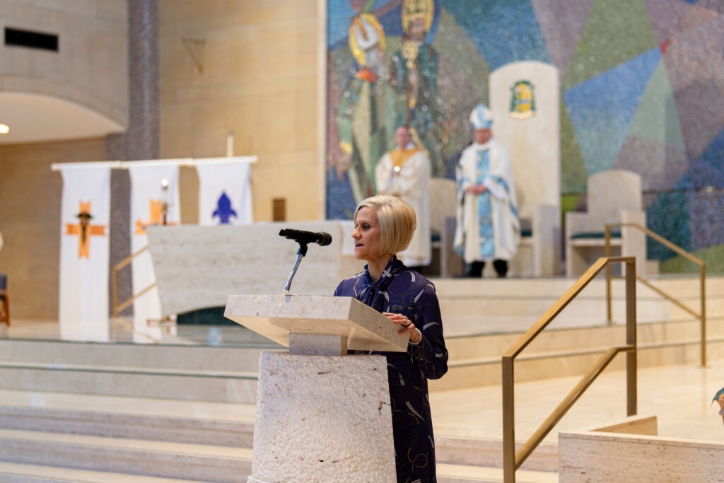 Rachel Hrbolich addresses the attendees at the cantor stand at the annual White Mass. Photo by Brian Keith.