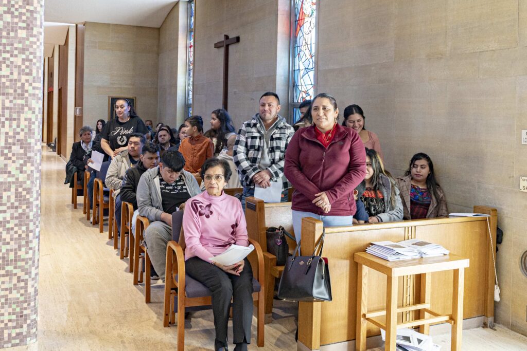Members of the Hispanic Community are seated together at one of the side altars during the 2024 Rite of Election. Photo by Brian Keith