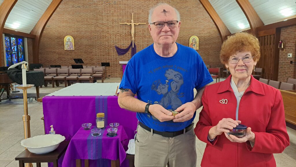 Volunteers help distribute ashes on Ash Wednesday at the Newman Center in Kent