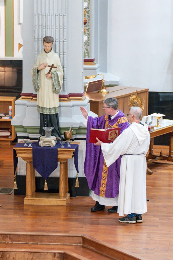 Father Leo Wehrlin blesses the Ashes on Ash Wednesday at Holy Trinity Parish in East Liverpool