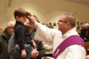 A deacon administers ashes on Ash Wednesday