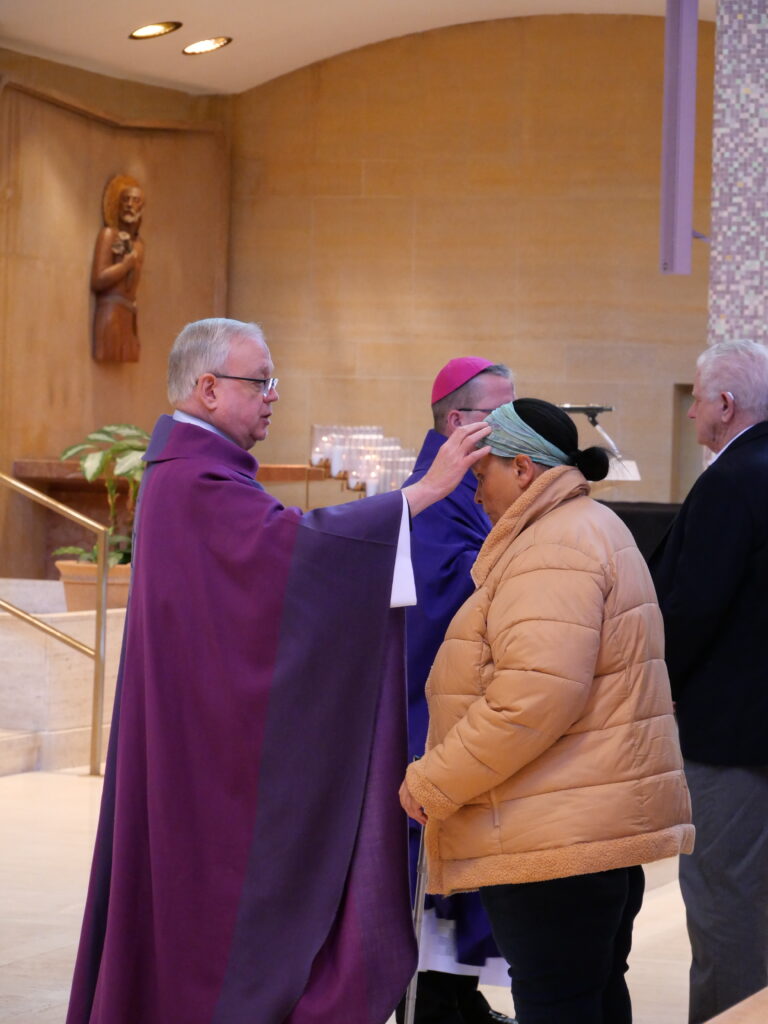Monsignor Robert Siffrin administers ashes on Ash Wednesday at St. Columba Cathedral