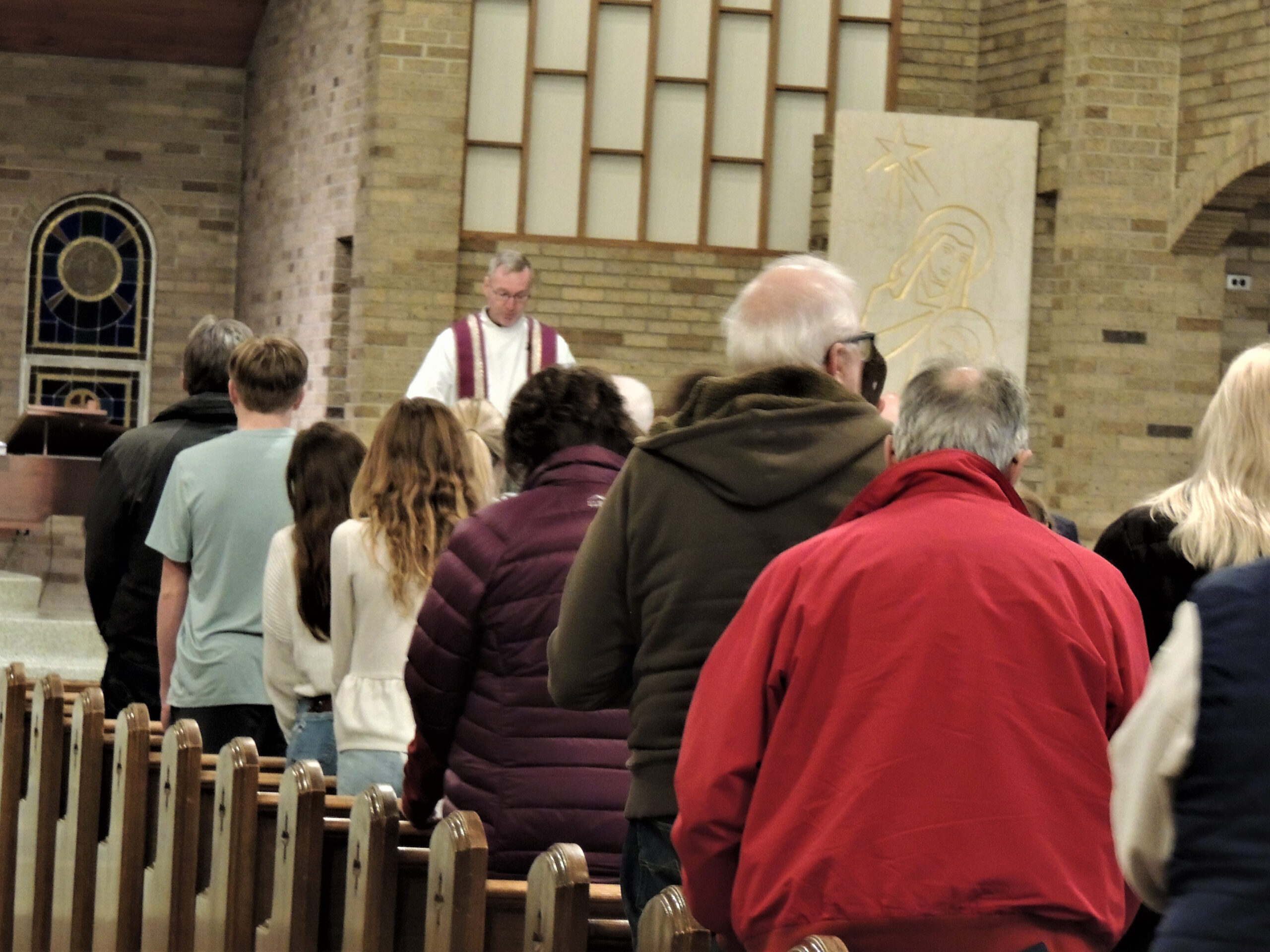 Parishioners stand during the communal reconciliaiton service
